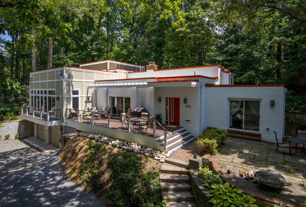 example of a contemporary home with white siding and red lining.