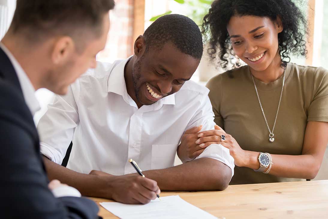 Black-couple-signing-documents-with-preferred-lender