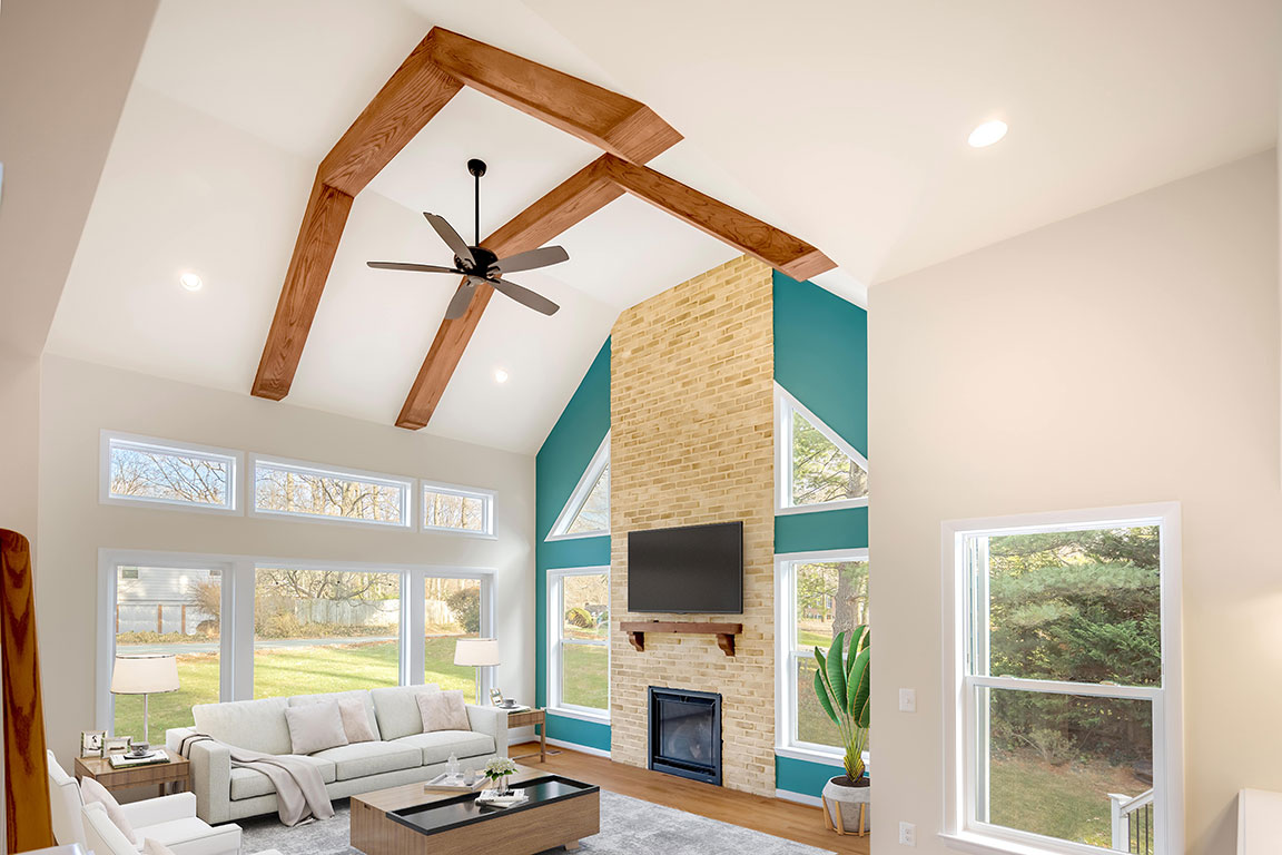 Interior of spacious remodeled living area with exposed wood beams in the ceiling