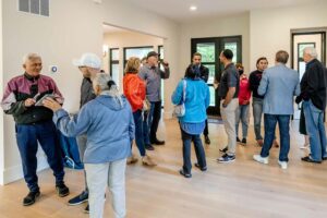 People gathering inside custom home open house event near Arlington