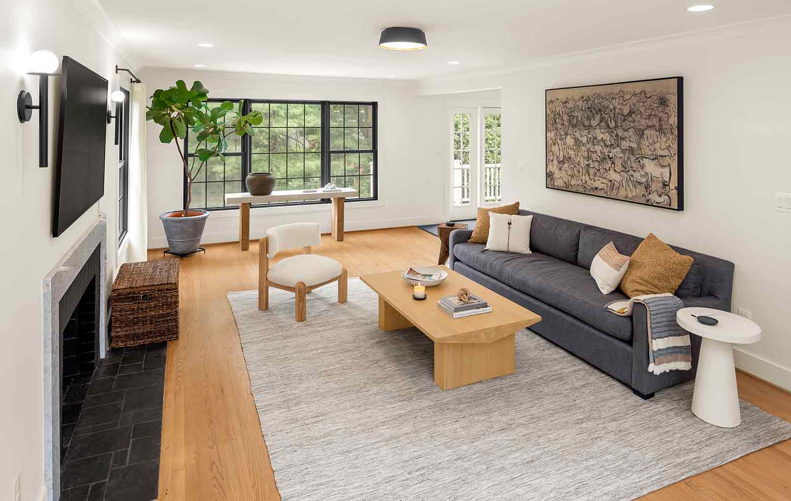 Spacious living room with natural light in renovated custom home