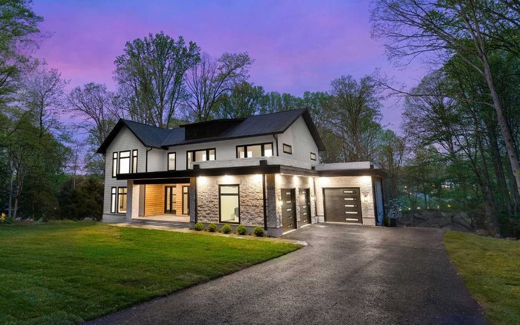 New-home-exterior-at-dusk-but-Paradigm-custom-home-builder